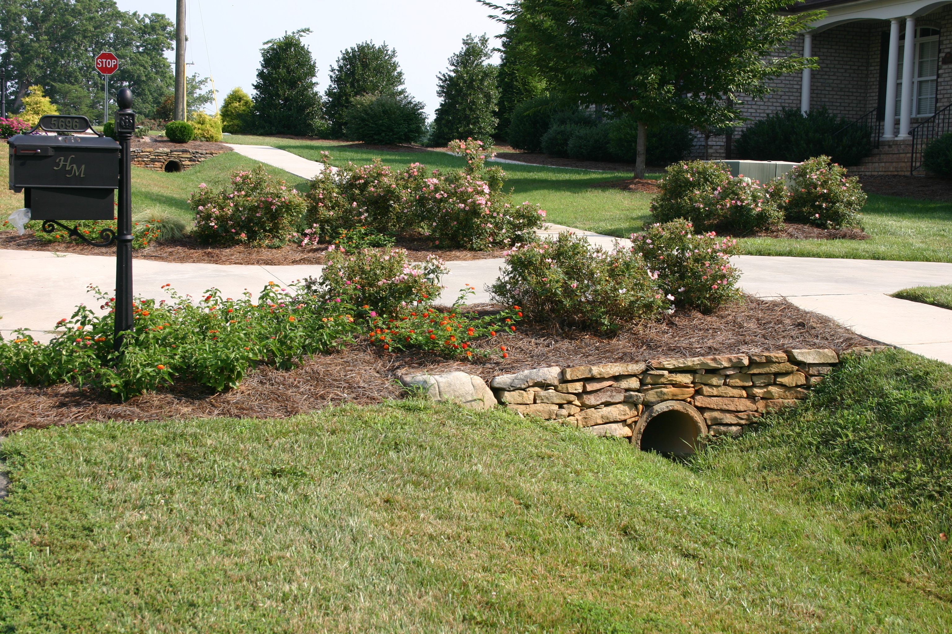 Field stones and landscaping add a nice touch to driveway culverts in ...